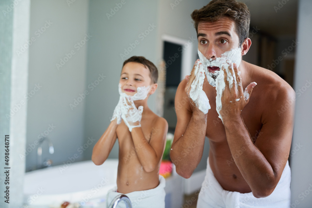 The shaving cream always comes first. Cropped shot of a handsome young man teaching his son how to s