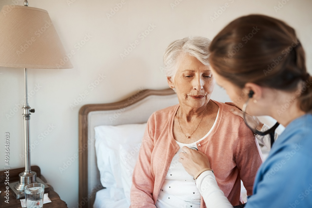 Lets see what your heart has to say. Shot of a senior woman getting a checkup from a young nurse in 