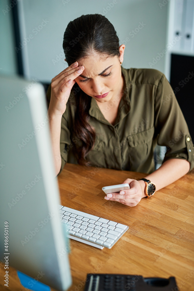 Some news can really put a damper on your day. Shot of a young businesswoman looking stressed out wh