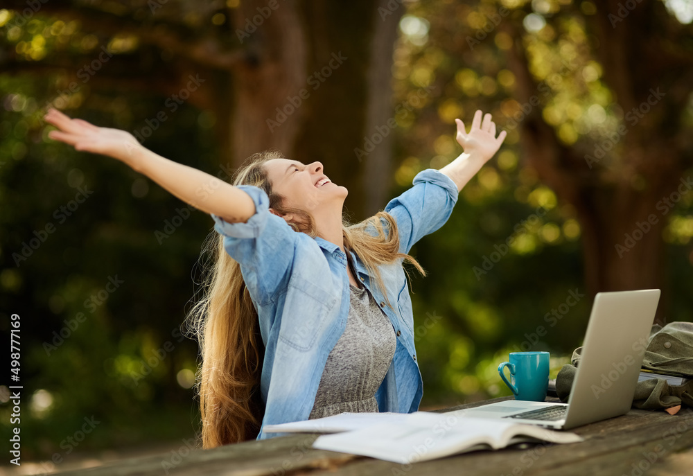 These exams have nothing on me. Shot of a young woman studying outdoors.