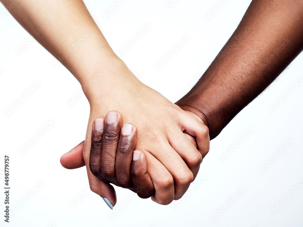 Unity is power. Studio shot of two unrecognizable people holding hands against a grey background.