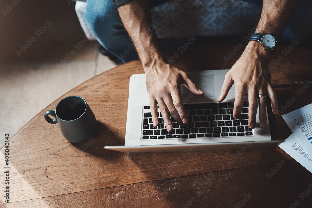 Create your own productive space. High angle shot of an unrecognizable businessman working on a lapt