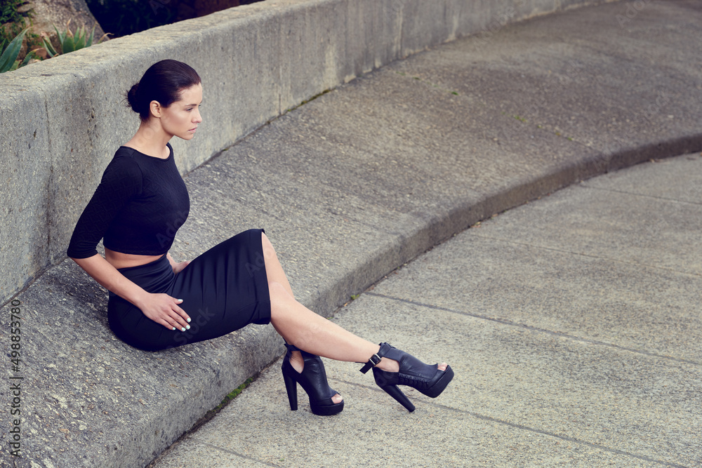 Concrete style. Full length shot of a beautiful fashion model posing in an empty urban setting.