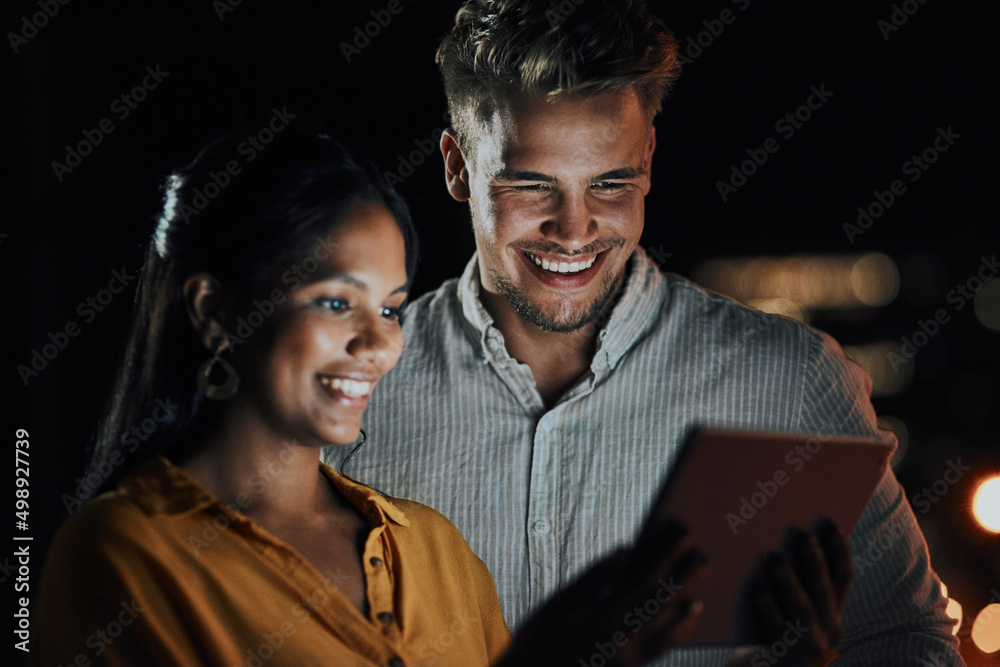 This app is perfect for what we need. Shot of two businesspeople using a digital tablet together out