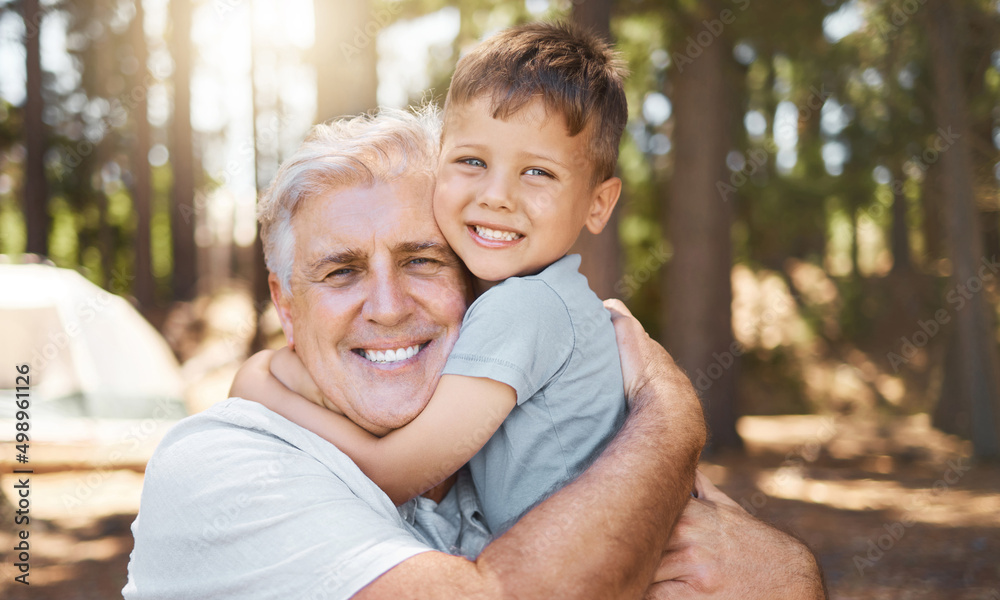 Hes my pride and joy. Cropped portrait of a handsome mature man and his grandfather hugging while ca