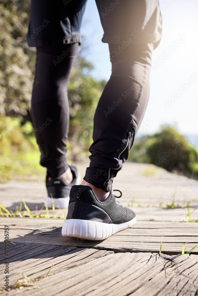 Its all about taking that first step. Cropped shot of an unrecognizable male athlete working on the 