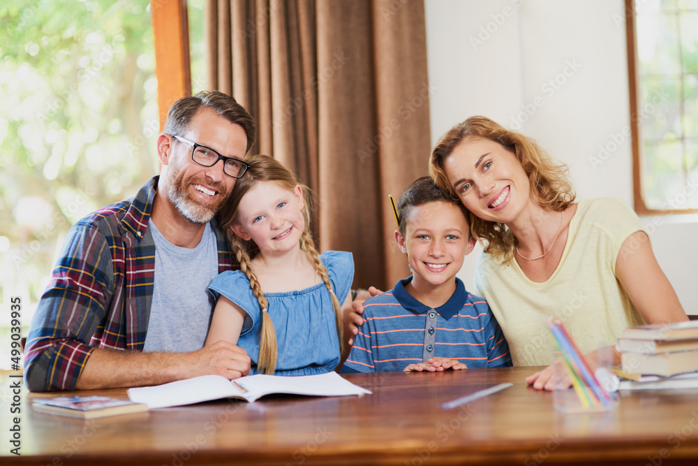 Always together and always here to help. Cropped shot of an affectionate family doing schoolwork tog