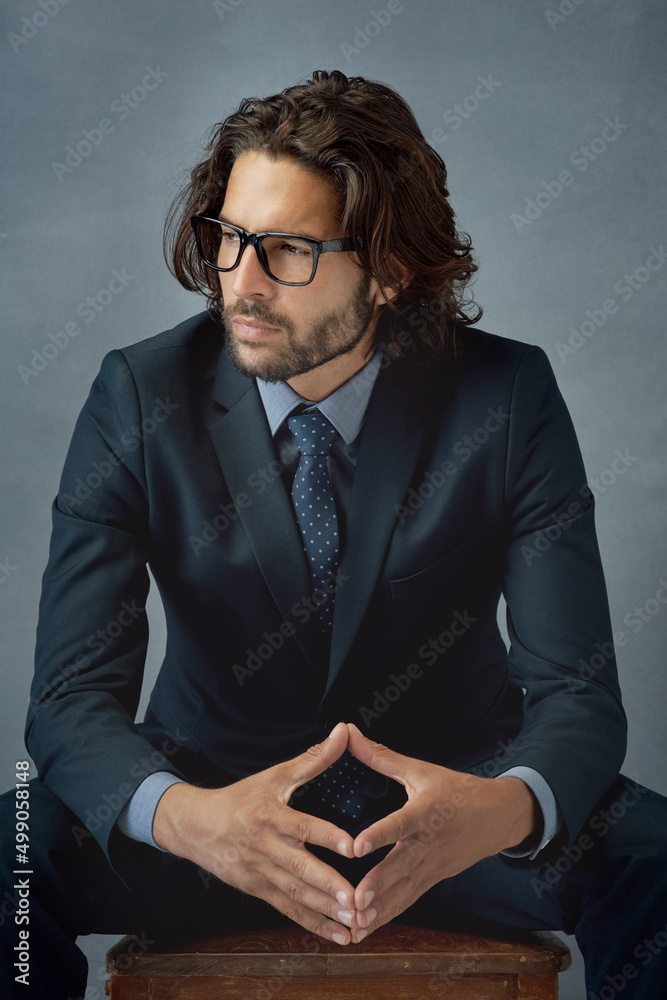 Being a gentleman shows in your appearance. Studio shot of a well-dressed businessman against a grey