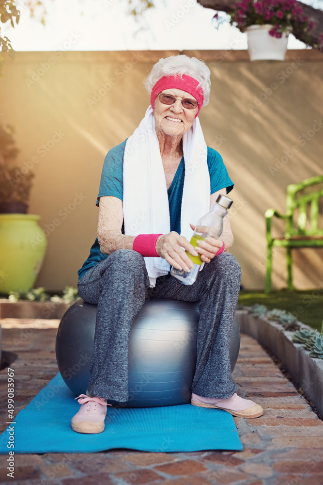 Maintaining an active lifestyle. Shot of a senior woman exercising at home.