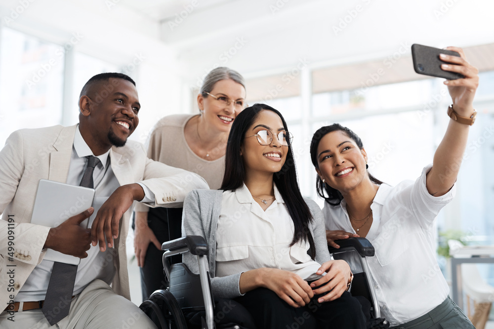 Introducing the team. Cropped shot of a group of diverse businesspeople taking selfies while gathere