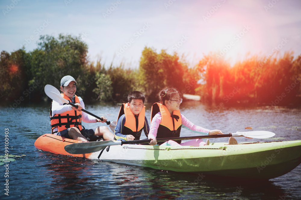 asian family sailing kayak boat in fresh water lake