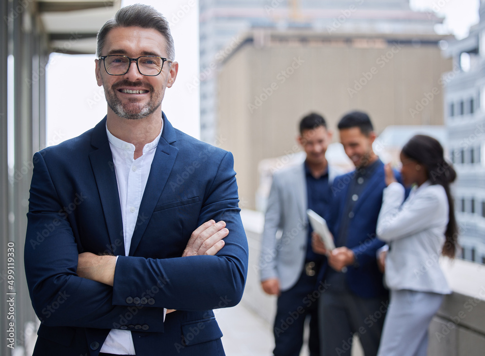 Confident with a great team behind me. Cropped portrait of a handsome mature businessman standing ou