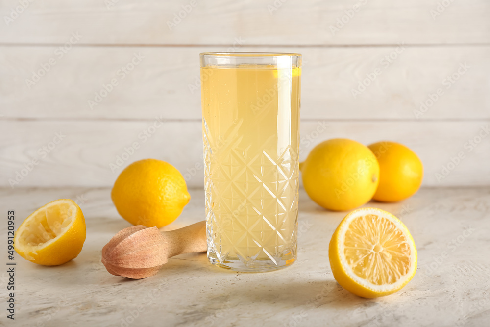 Glass of lemon juice on table