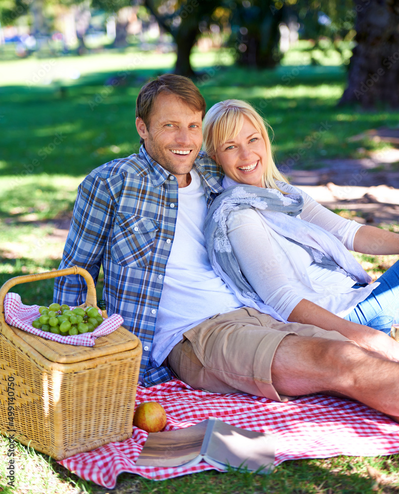 Enjoying a romantic day outdoors. Shot of an affectionate couple enjoying a picnic in the sun.