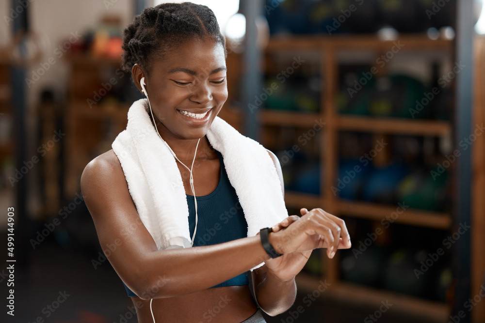 Hows my time looking. Cropped shot of an attractive and athletic young woman checking her sports wat