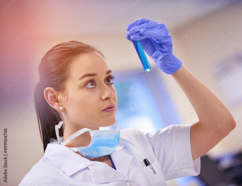 It all comes down to this. Shot of a young scientist examining liquid in a test tube in a laboratory