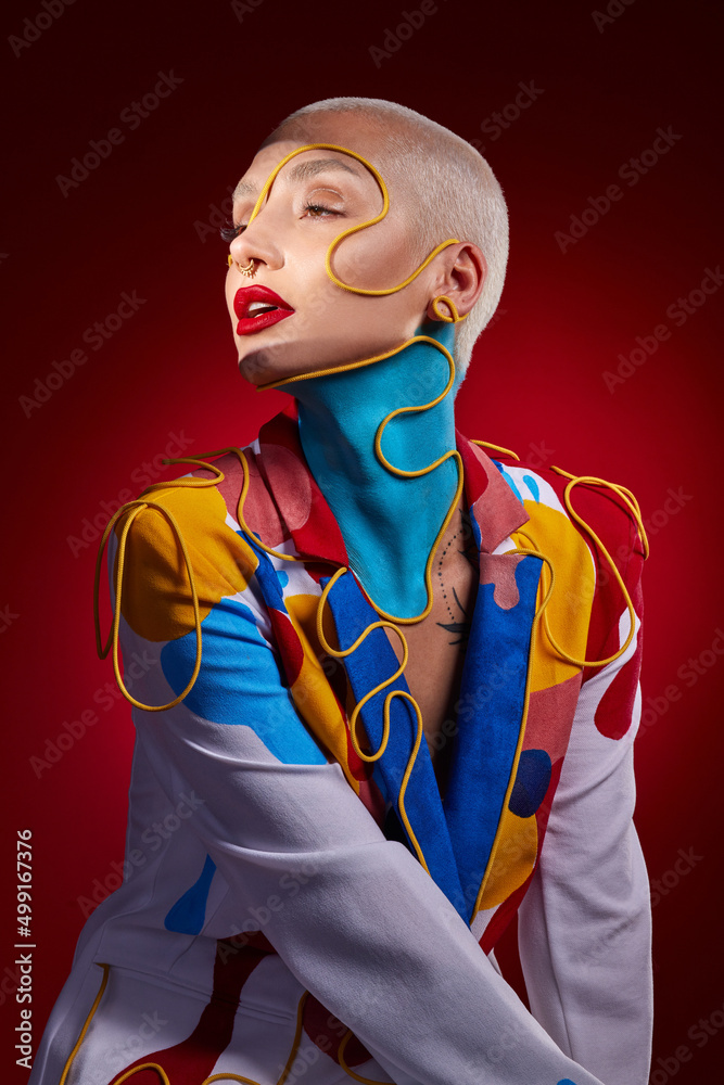 Be the one who makes them stop and stare. Studio shot of a stylish young woman posing against a red 