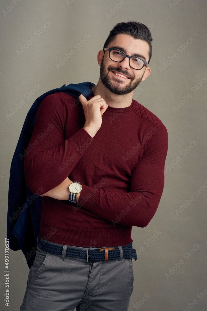 Hes dressed to really impress. Studio portrait of a handsome young man posing against a grey backgro