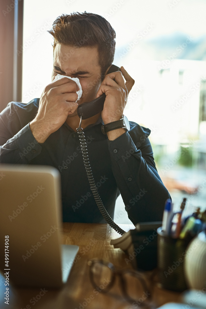 It might be time to schedule that appointment with the doctor. Shot of a young businessman blowing h