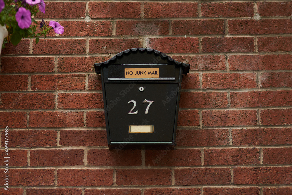 Mounted mailbox. Full length shot of a letter box on a wall.