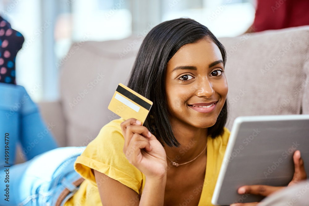 Mom said I could go shopping with her card. Shot of a teenage girl using a tablet and credit card at