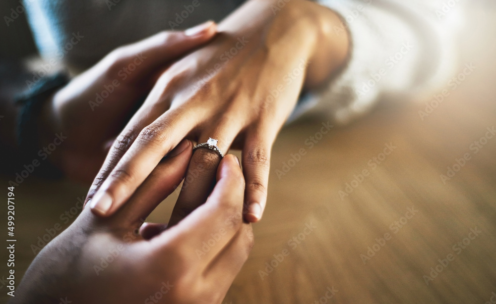 Will you make me the happiest man and marry me. Cropped shot of a man putting an engagement ring ont