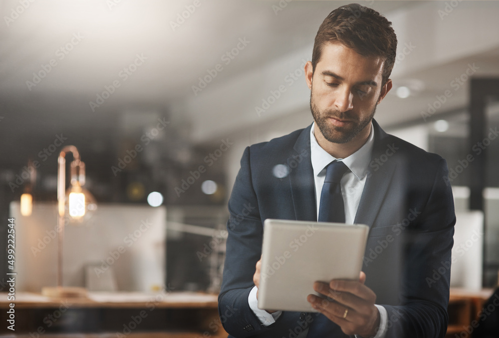 There are so many apps to make make smarter moves. Shot of a young businessman using a digital table