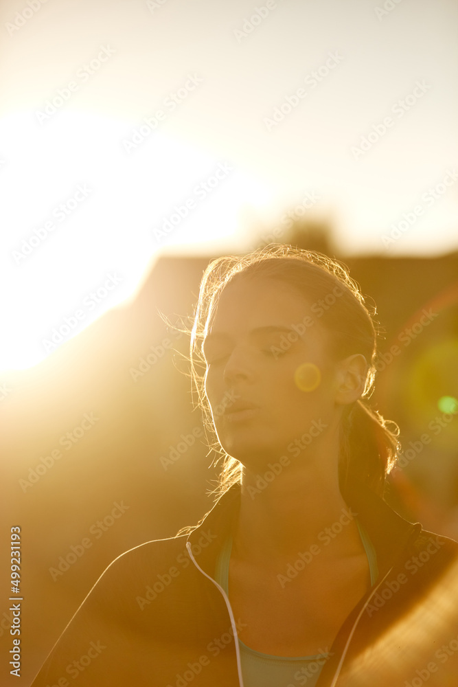 Youre not sweating, youre glowing. Shot of a sporty young woman taking a break while exercising outd