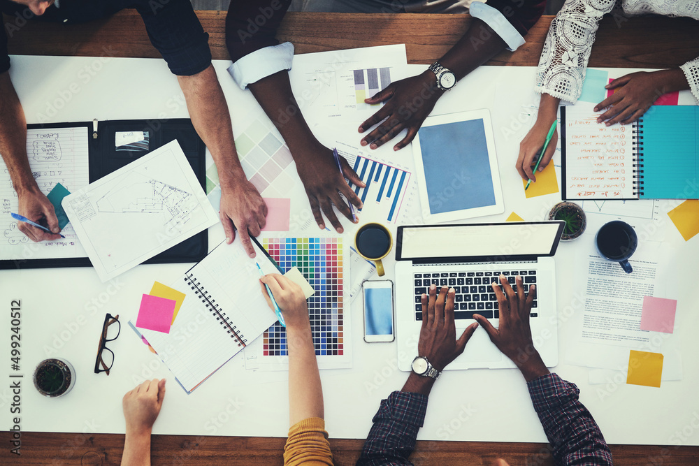 All hands in for a new creative project. High angle shot of a group of businesspeople having a meeti