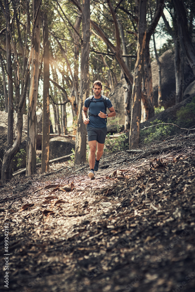 Hitting the hiking trail at full space. Full length shot of a handsome young man running during his 