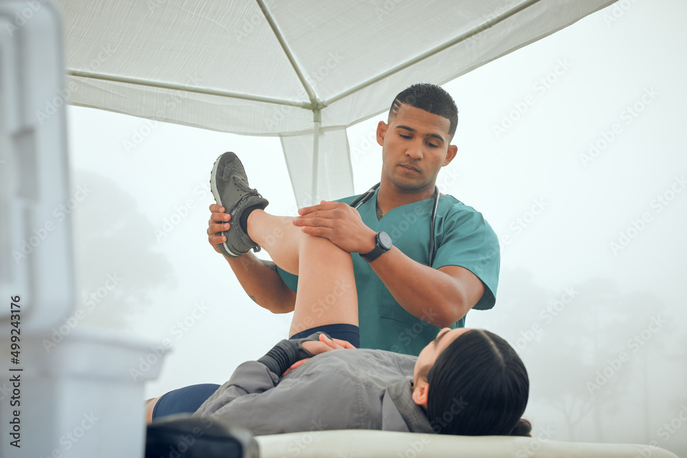 How does that feel. Cropped shot of a handsome young male physiotherapist working on a female patien