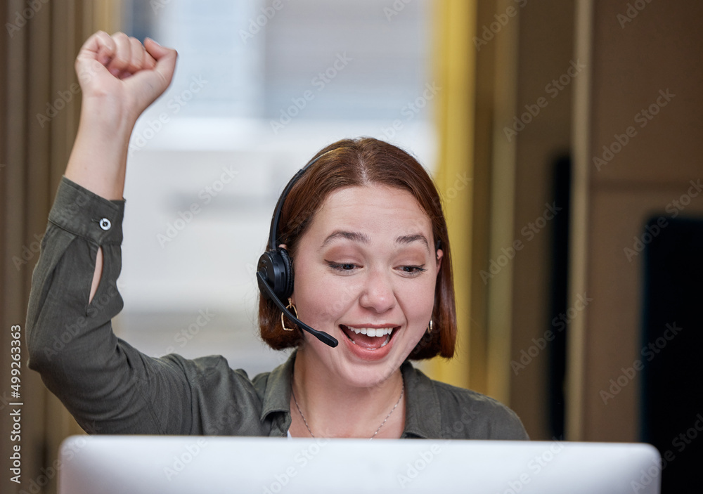 Im so glad I could help. Shot of a young call centre agent sitting alone in the office and celebrati