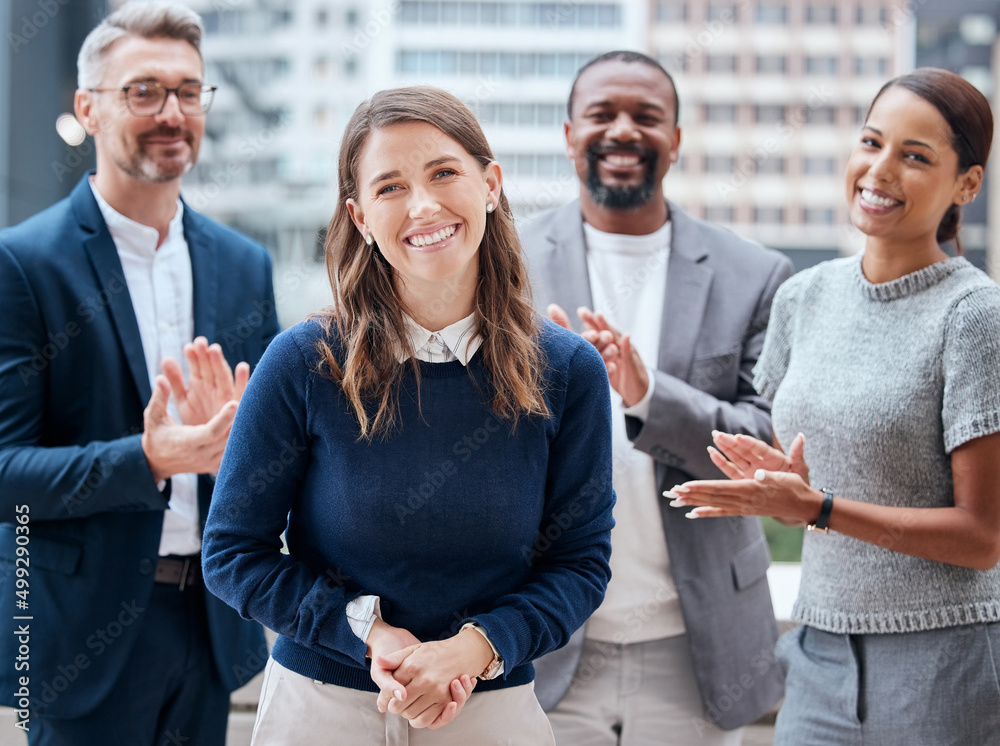 Sweat makes the dream work. Portrait of a young businesswoman being applauded by her team.