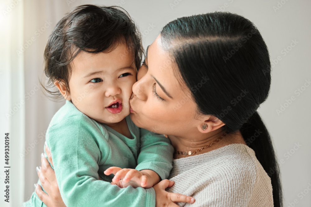 I cant tell you enough how much I love you. Shot of a beautiful young woman bonding with her baby at