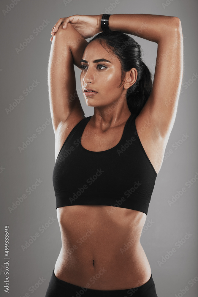 Working towards my fitness goals. Studio shot of a fit young woman against a gray background.