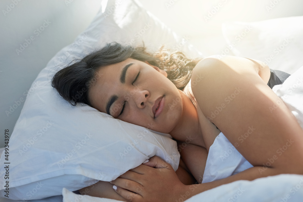 Lost in a peaceful slumber. Shot of an attractive young woman sleeping in bed.