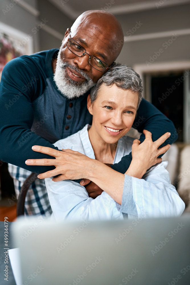 The one that always makes things better. Shot of a senior married couple using a laptop at home.