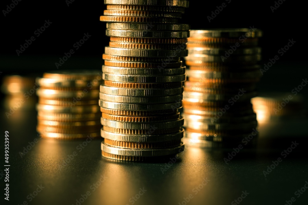 Pile of gold coins stack in finance treasury deposit bank account for saving . Concept of corporate 