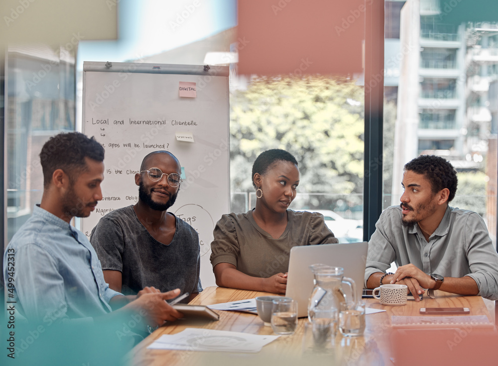 Time to get down to business. Shot of a group of young businesspeople having a discussion at the off