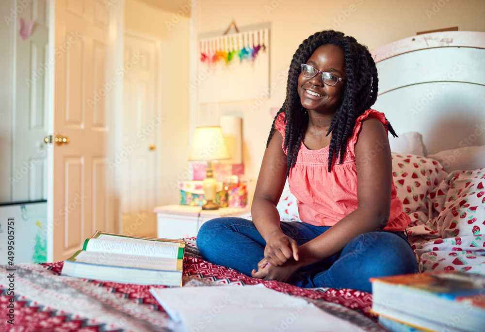 Taking a quick break then back to my homework. Shot of an adorable little girl doing her homework on