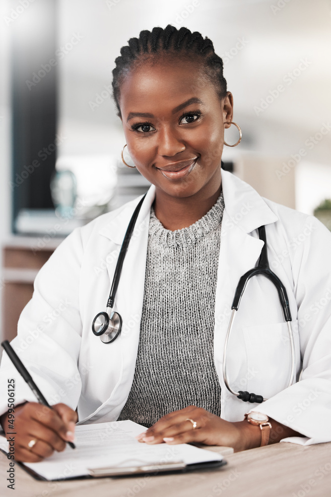 Come see me for a clean bill of health. Shot of a young doctor making notes at her desk.