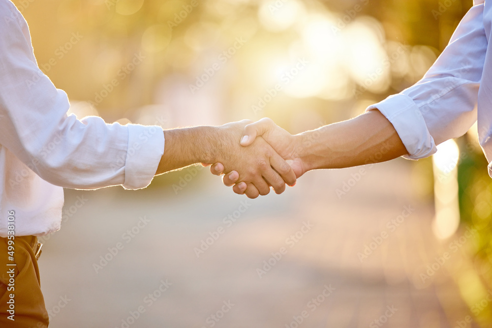 Youve got yourself a deal. Cropped shot of two unrecognizable businessmen standing in the city toget