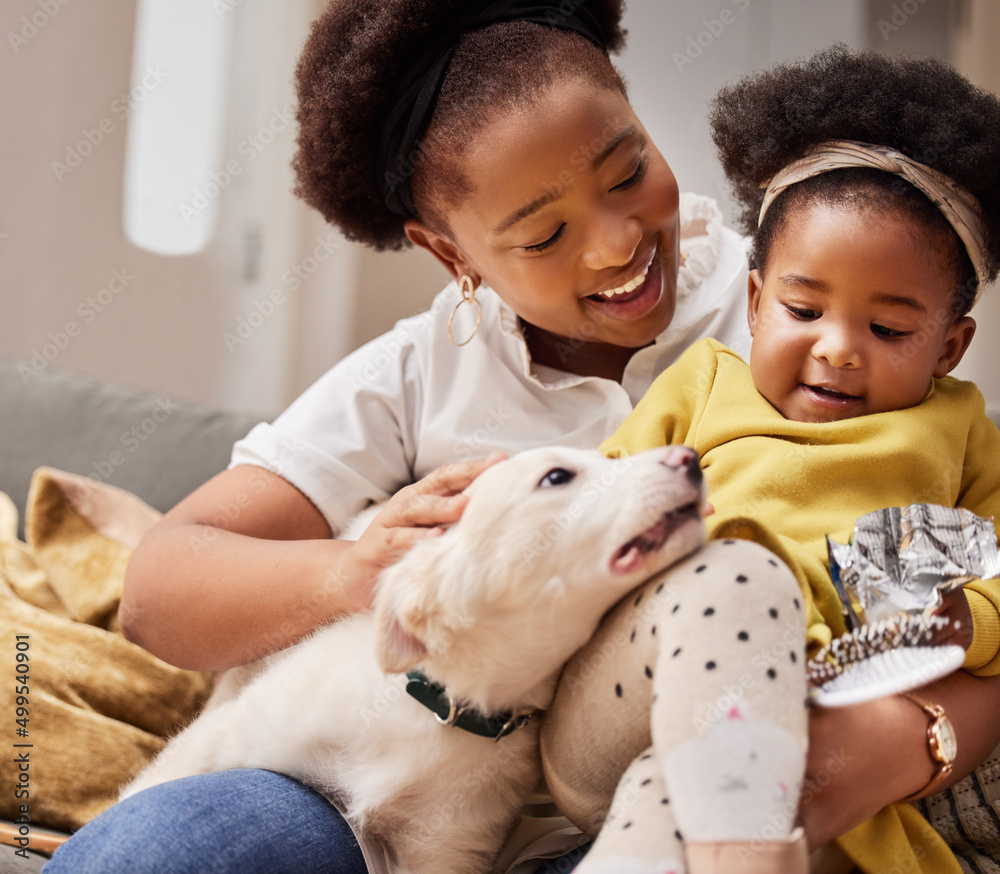 He completes our family. Shot of a young mother and daughter relaxing with their pet at home.