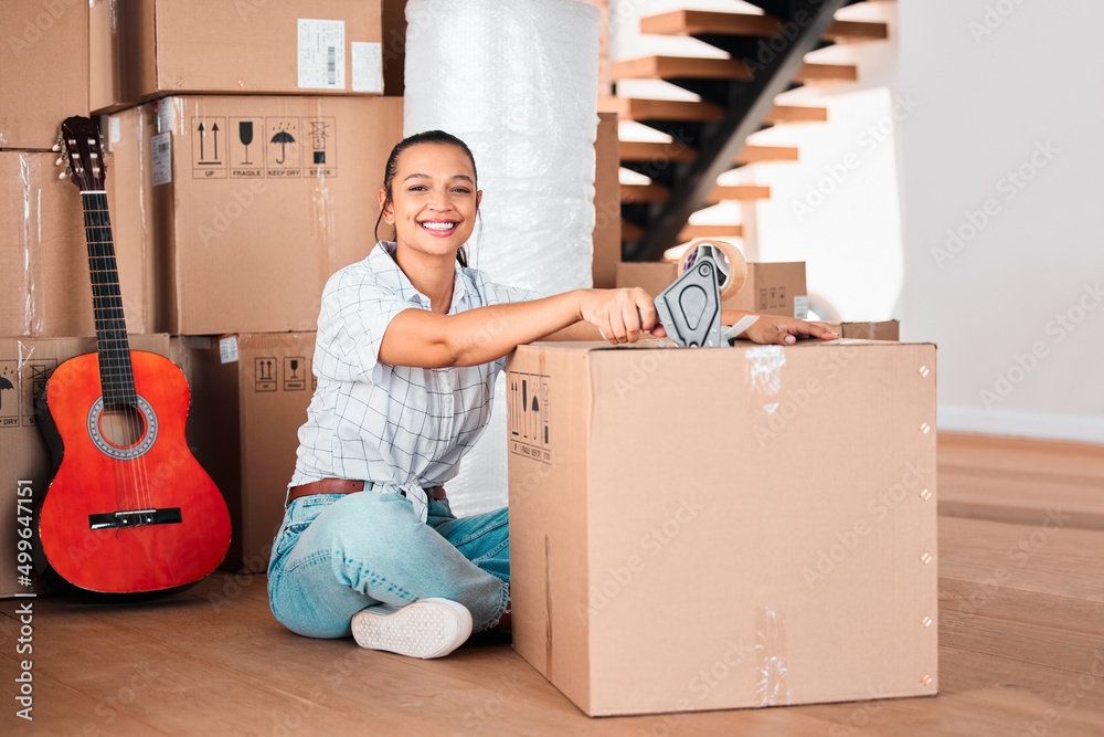 Im moving on to bigger and better things. Shot of a young woman sealing cardboard boxes with sellota