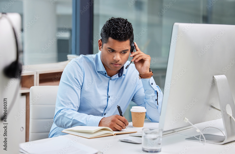 Im already thinking of solutions. Shot of a handsome young businessman sitting alone in his office a