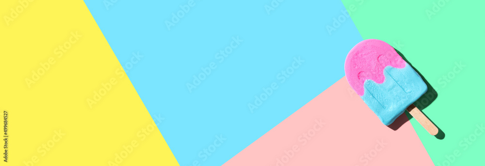 Pink and blue popsicle with shadow - overhead view