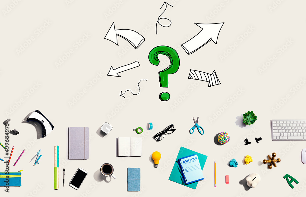 Question mark with arrows with collection of electronic gadgets and office supplies