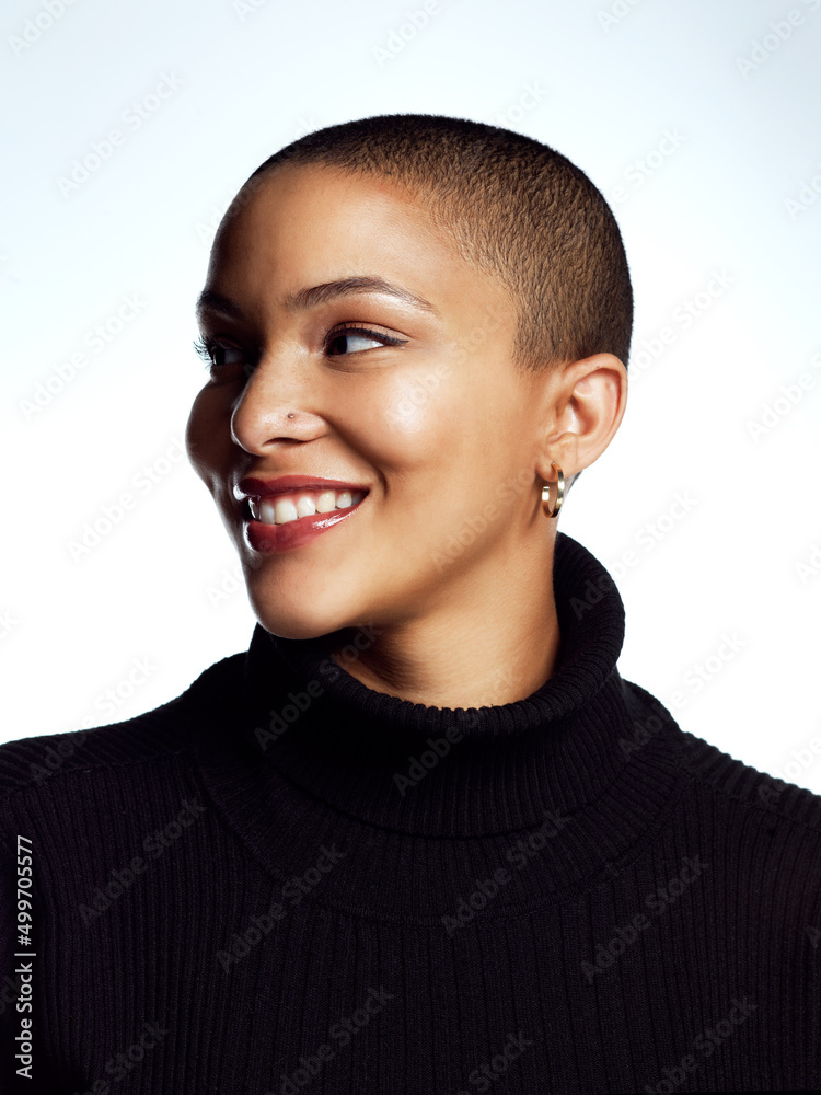 Im happy in my own skin. Studio shot of an attractive young woman posing against a grey background.