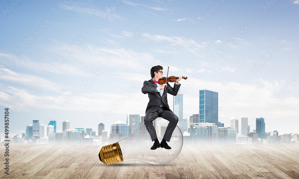 Young businessman plays the violin