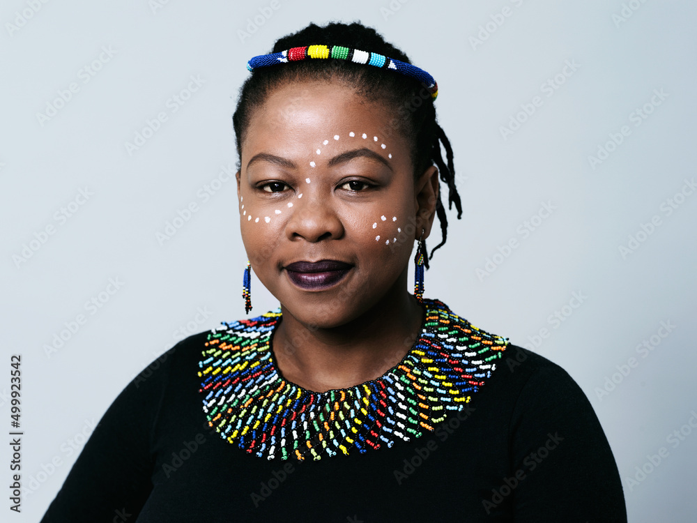 Patterns and colors are part of their heritage. Studio portrait of a confident middle aged woman loo